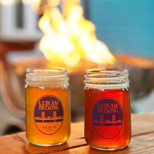 leikam beers in mason jars in front of fire pit